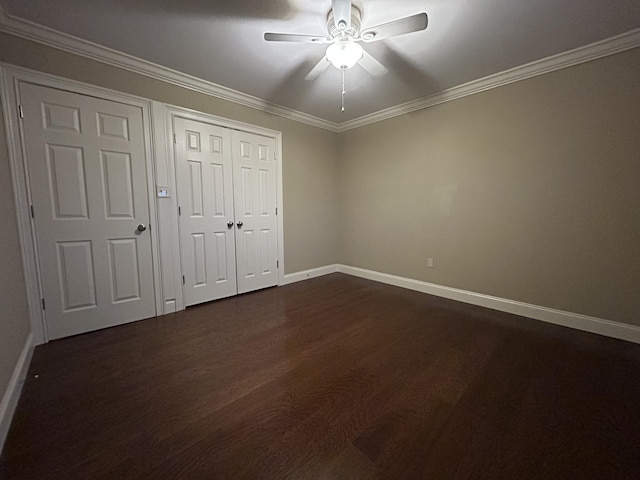 unfurnished bedroom with dark wood-type flooring, ceiling fan, and crown molding