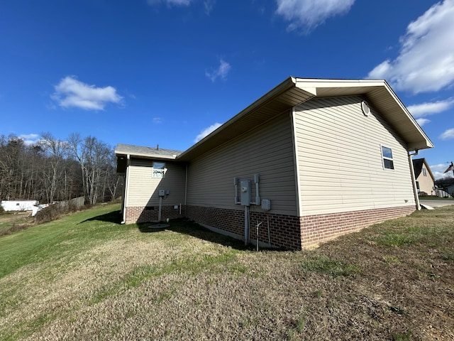 view of side of home featuring a yard