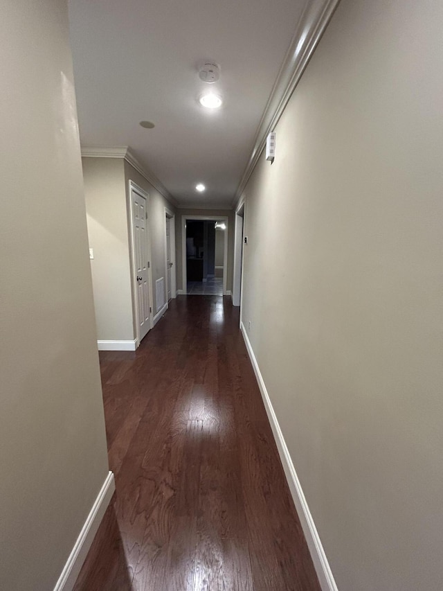 hallway featuring crown molding and dark hardwood / wood-style floors