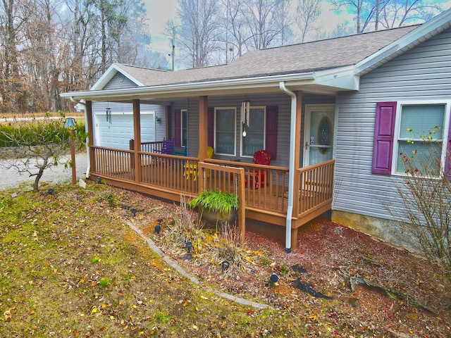 exterior space featuring covered porch and a garage