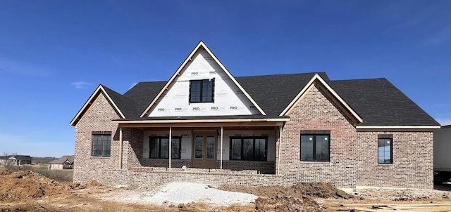 view of front of house featuring french doors and brick siding