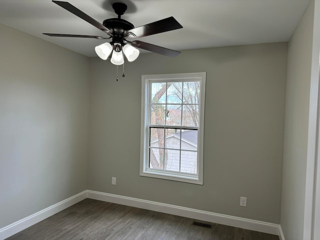 empty room with ceiling fan and dark wood-type flooring