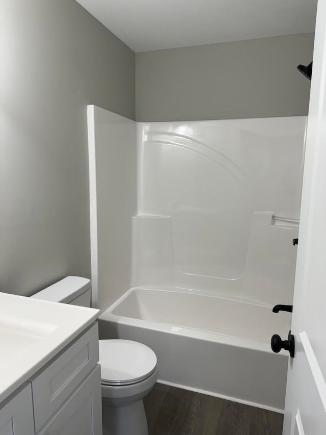 full bathroom featuring toilet, vanity, bathtub / shower combination, and hardwood / wood-style flooring