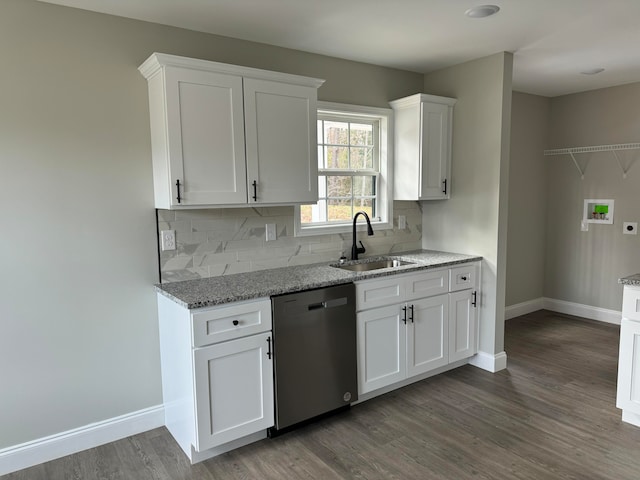 kitchen with dishwasher, sink, light stone counters, dark hardwood / wood-style floors, and white cabinets