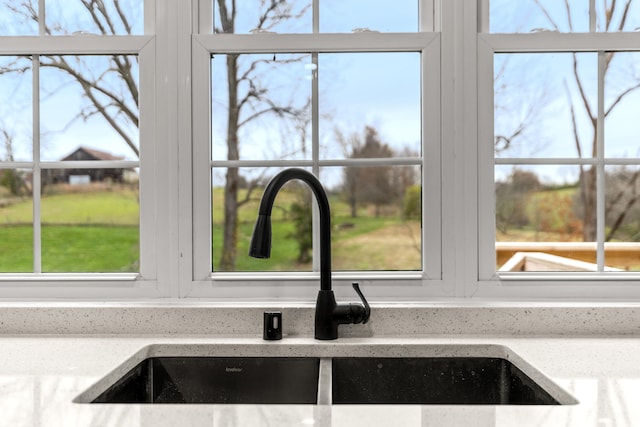 interior details with light stone countertops and sink