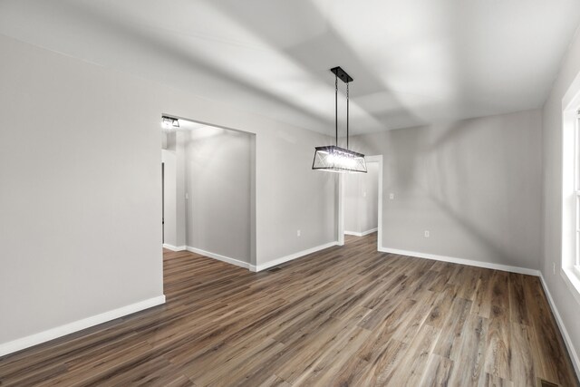 unfurnished dining area featuring dark hardwood / wood-style flooring