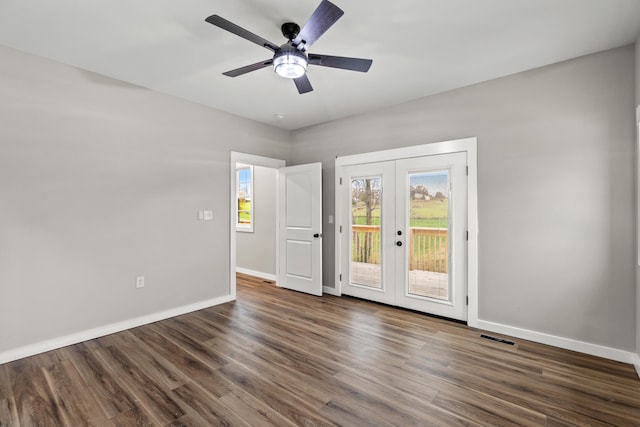 empty room featuring dark hardwood / wood-style floors, ceiling fan, and french doors