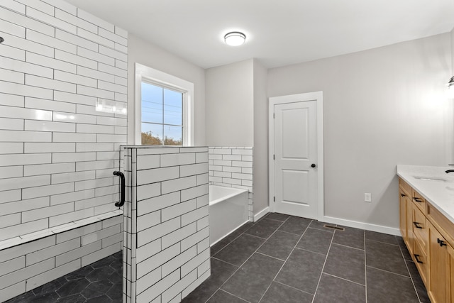 bathroom with tile patterned floors, vanity, and shower with separate bathtub