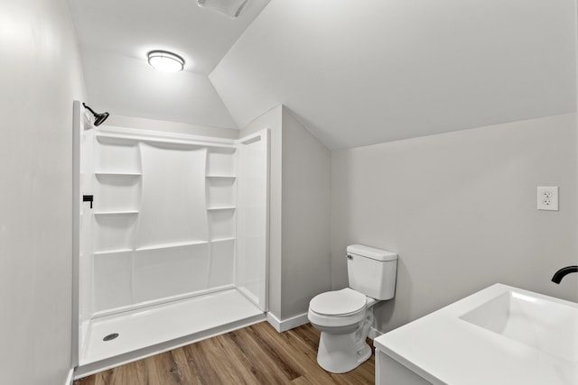 bathroom featuring walk in shower, lofted ceiling, toilet, vanity, and hardwood / wood-style flooring