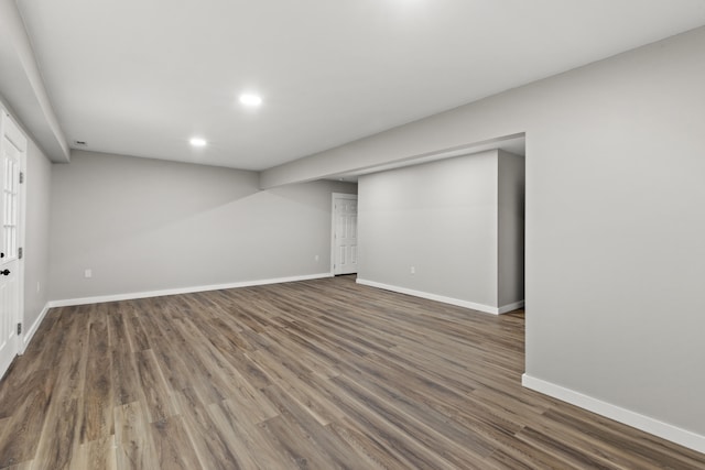 basement with dark hardwood / wood-style flooring