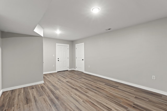 empty room with hardwood / wood-style flooring