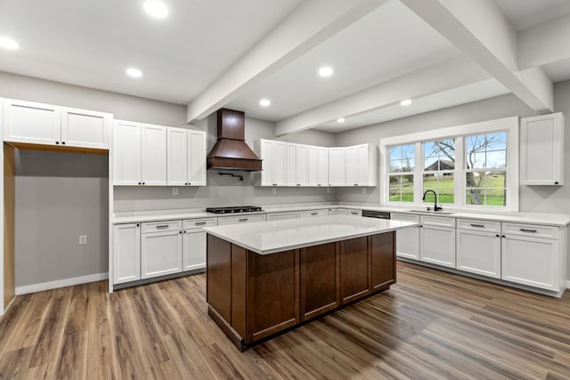 kitchen featuring dark hardwood / wood-style floors, white cabinetry, custom range hood, and stainless steel gas cooktop