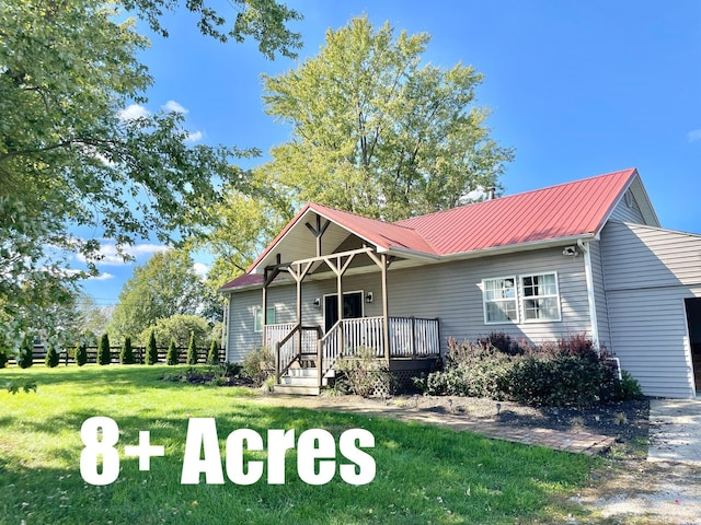 view of front of property with covered porch and a front yard