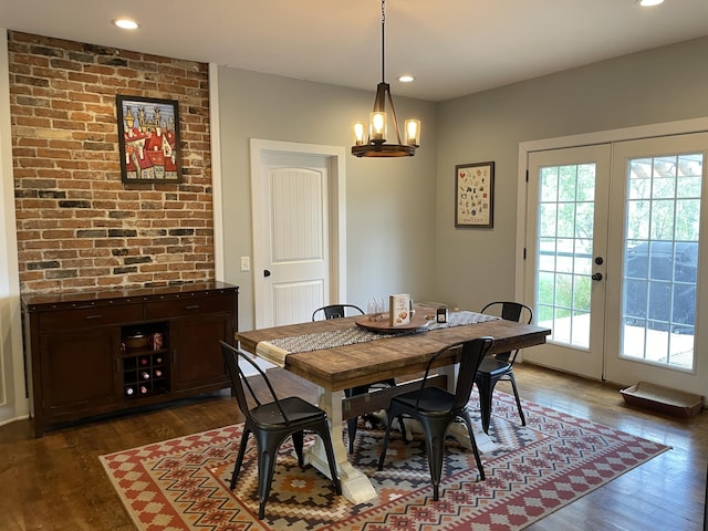 dining room featuring a chandelier, french doors, and dark wood-type flooring