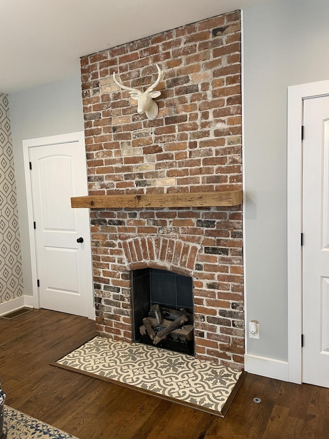 room details featuring a fireplace and wood-type flooring