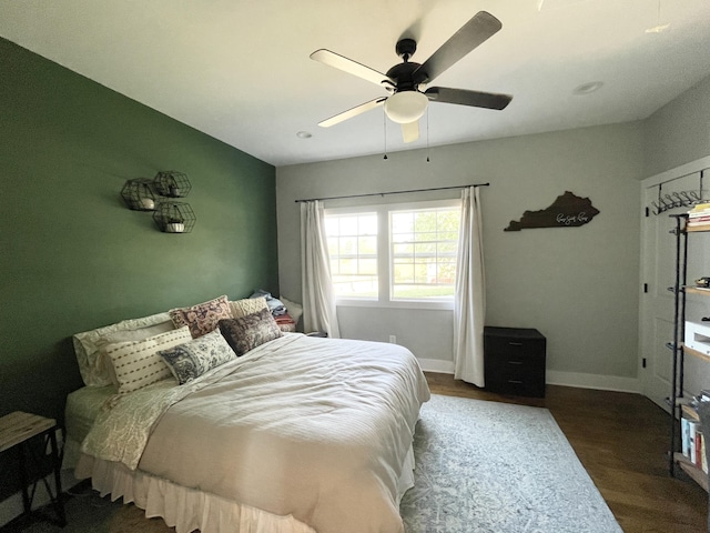 bedroom featuring ceiling fan and dark hardwood / wood-style floors