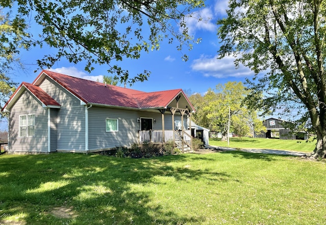 view of side of home with a yard