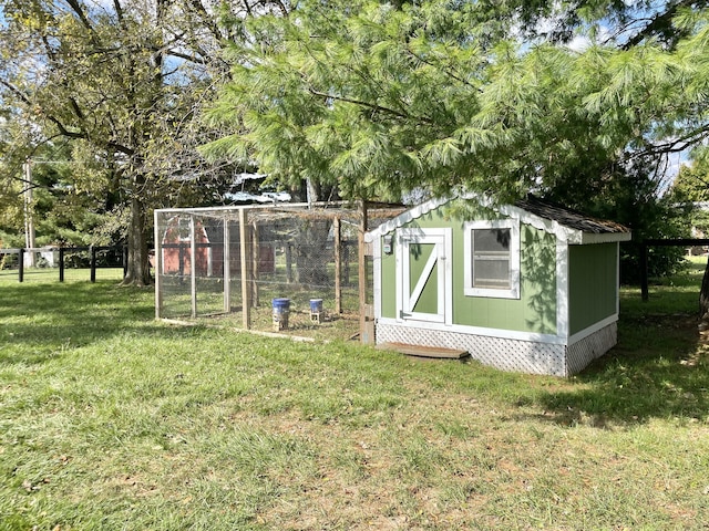 view of outdoor structure featuring a lawn