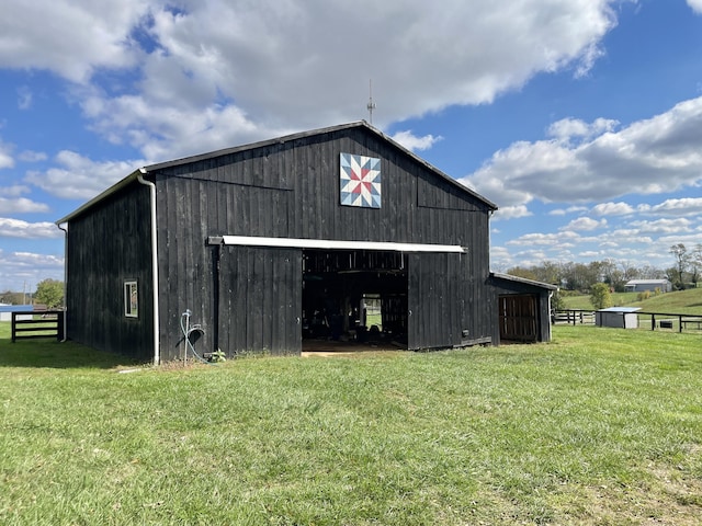 view of outbuilding featuring a lawn