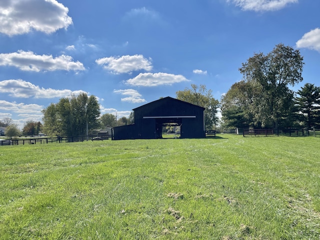 view of yard featuring a rural view and an outdoor structure