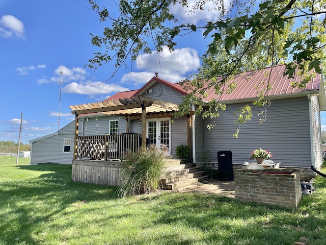 rear view of property featuring a pergola and a lawn