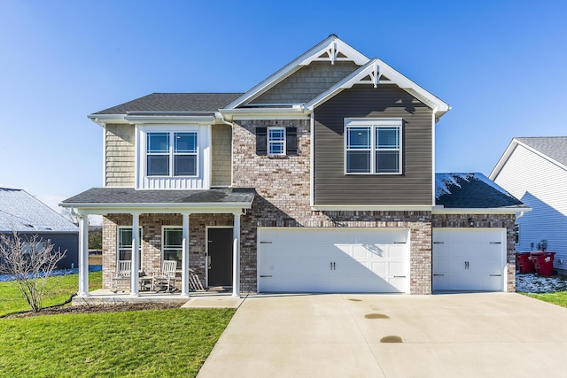 craftsman house with a front lawn, covered porch, and a garage