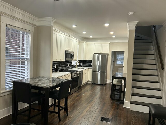 entrance foyer with dark hardwood / wood-style flooring and crown molding