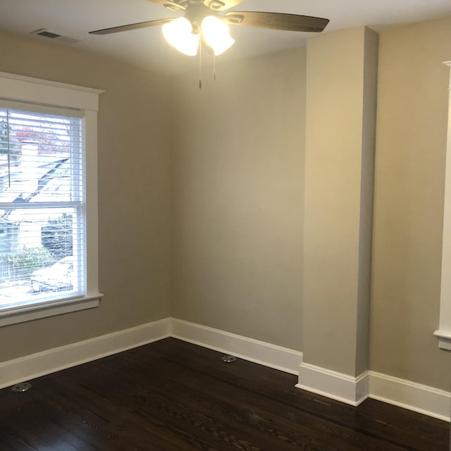 unfurnished room with ceiling fan and dark hardwood / wood-style floors