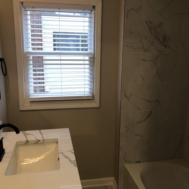 bathroom featuring vanity and tiled shower / bath combo