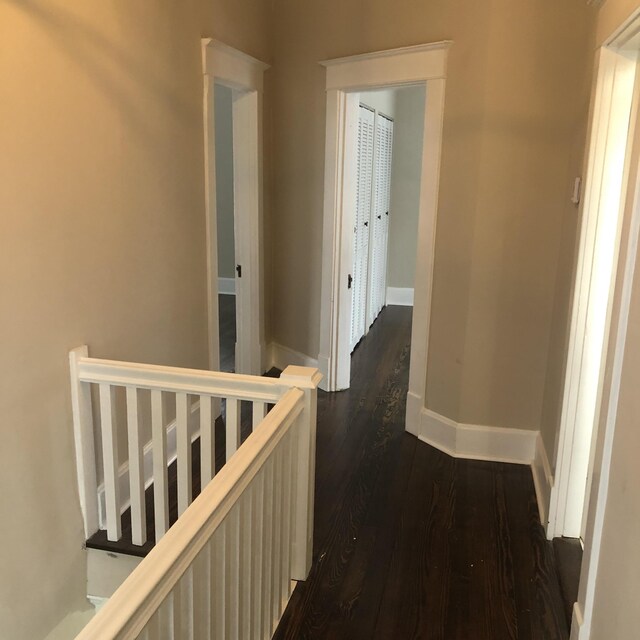 hallway with dark hardwood / wood-style floors