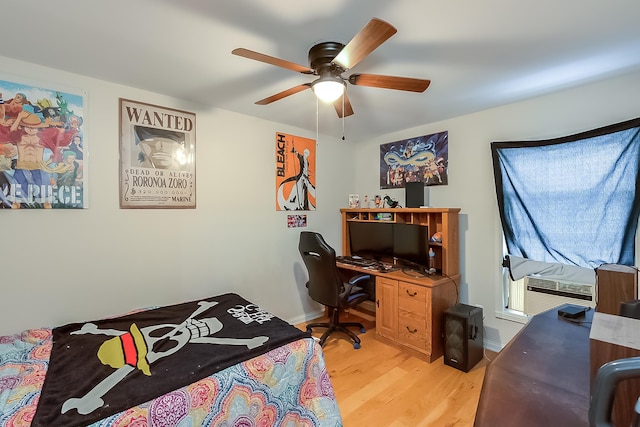 bedroom featuring light hardwood / wood-style floors, ceiling fan, and cooling unit