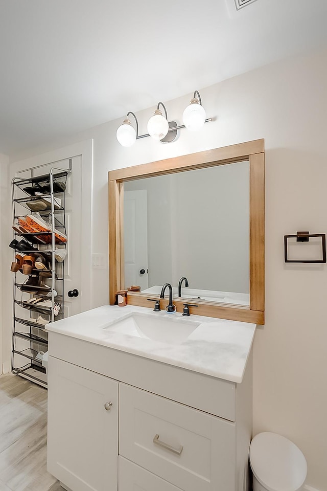 bathroom with hardwood / wood-style floors and vanity