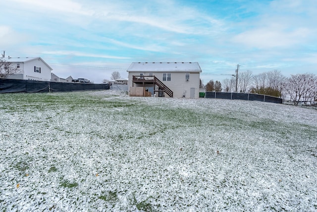 back of property with a yard and a deck