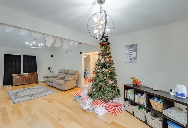 living room with a chandelier and hardwood / wood-style flooring