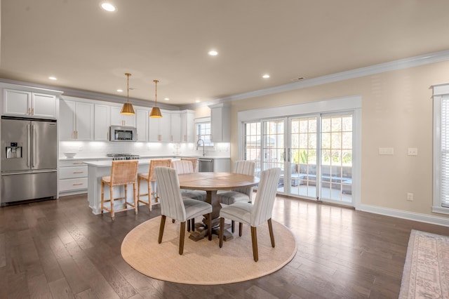 dining room featuring dark hardwood / wood-style flooring and ornamental molding