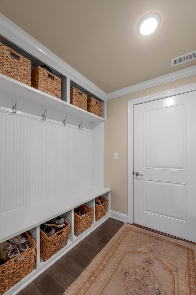 mudroom featuring crown molding and dark wood-type flooring