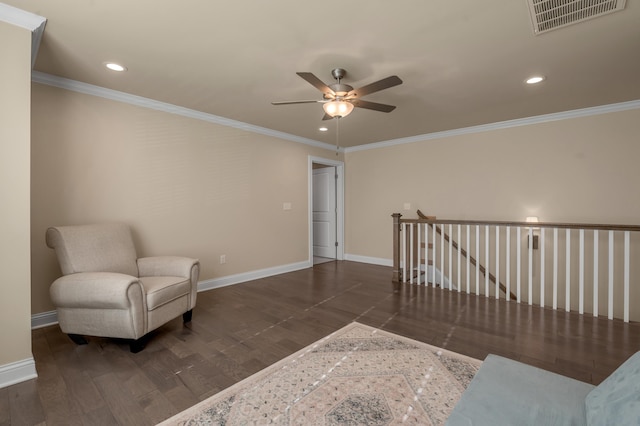 sitting room with dark hardwood / wood-style floors, ceiling fan, and ornamental molding