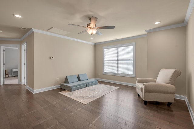 sitting room featuring dark hardwood / wood-style flooring, ceiling fan, and ornamental molding