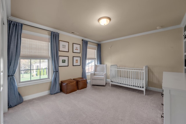 bedroom featuring carpet floors, a nursery area, and crown molding