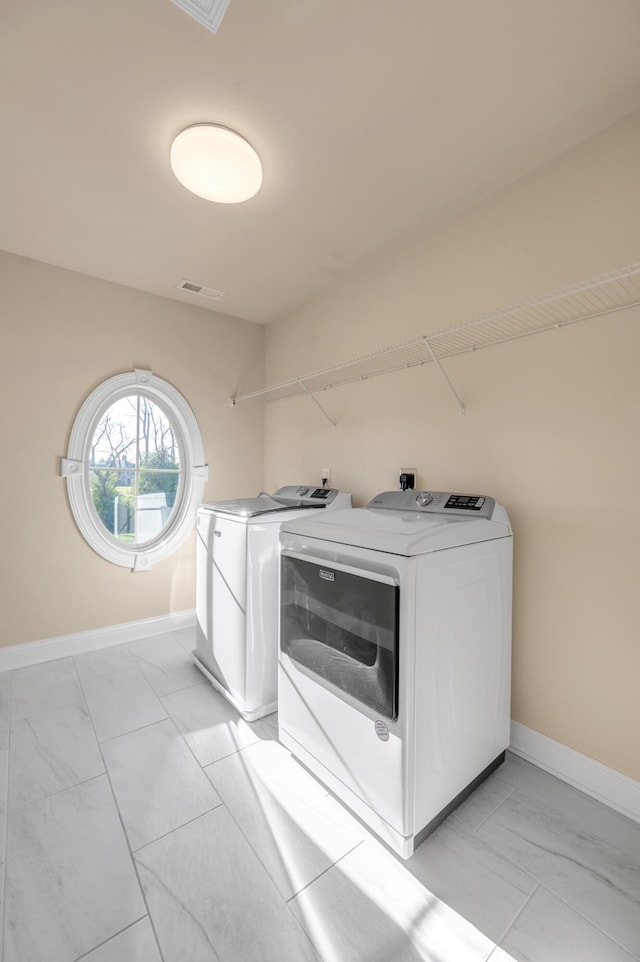 laundry room featuring separate washer and dryer