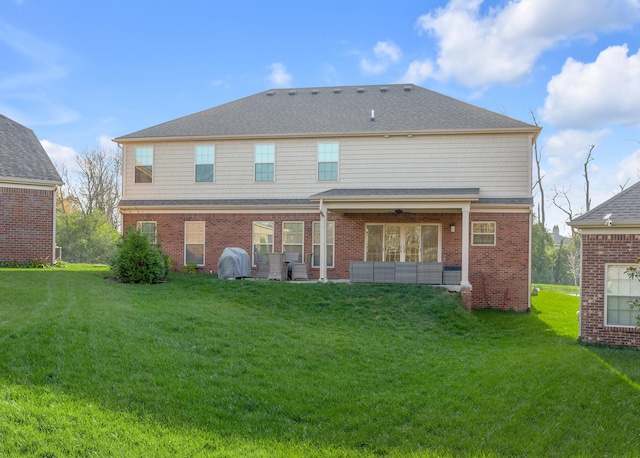 rear view of house featuring a yard