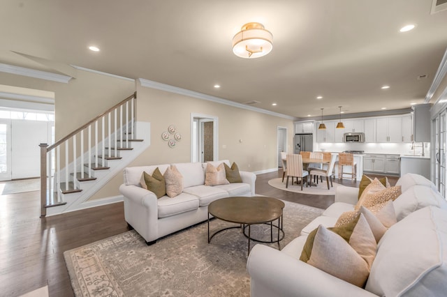 living room with dark hardwood / wood-style flooring and ornamental molding