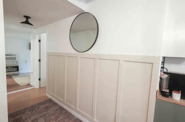 bathroom featuring heating unit and hardwood / wood-style flooring