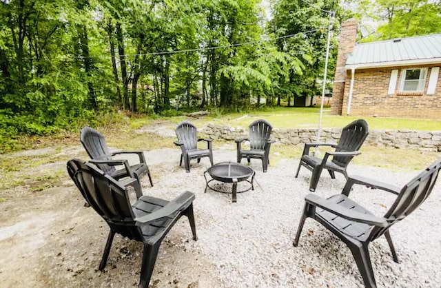 view of patio / terrace featuring an outdoor fire pit