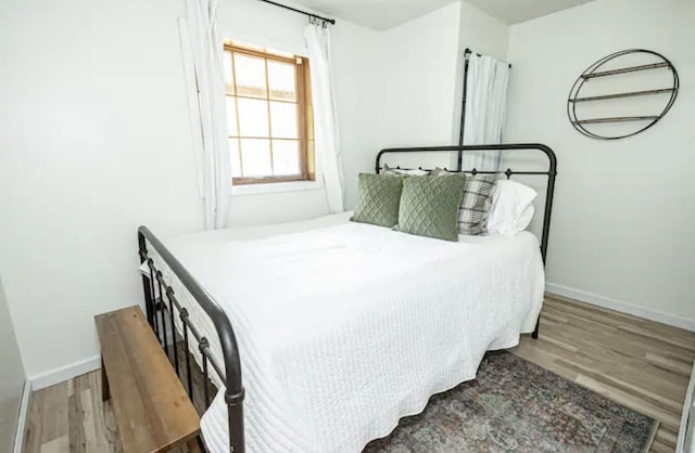 bedroom with hardwood / wood-style floors