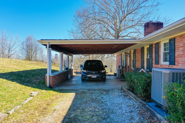 exterior space with central air condition unit and a carport