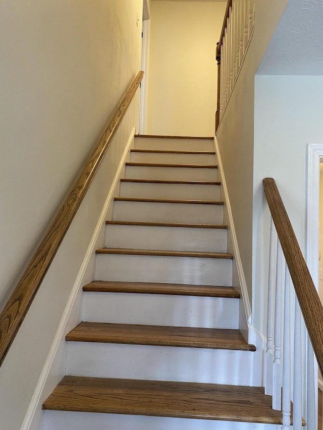 staircase with hardwood / wood-style floors