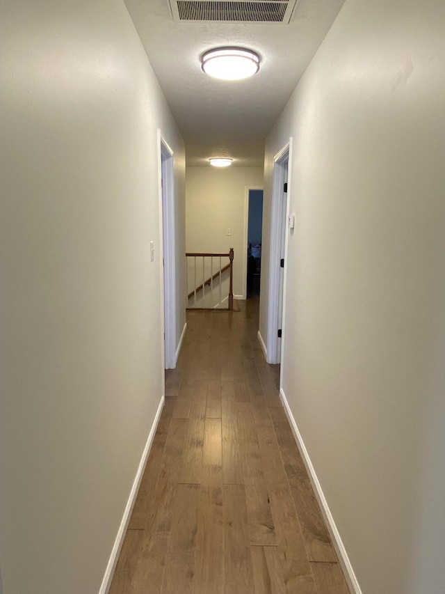 hallway featuring hardwood / wood-style flooring