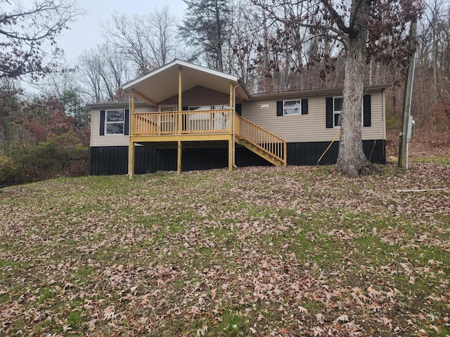 rear view of house with stairway and a deck