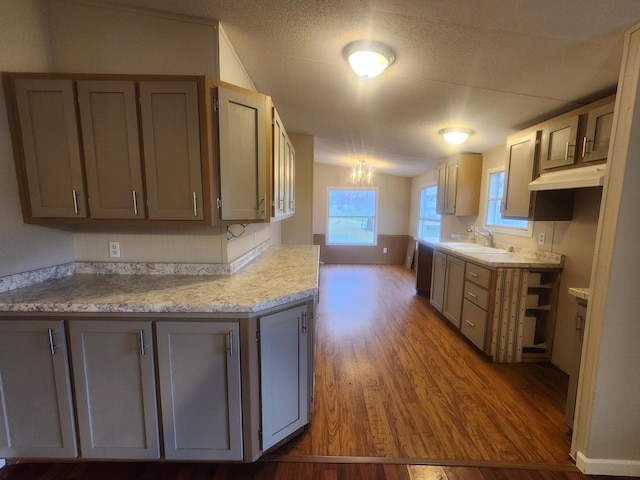 kitchen with light countertops, a sink, and gray cabinetry